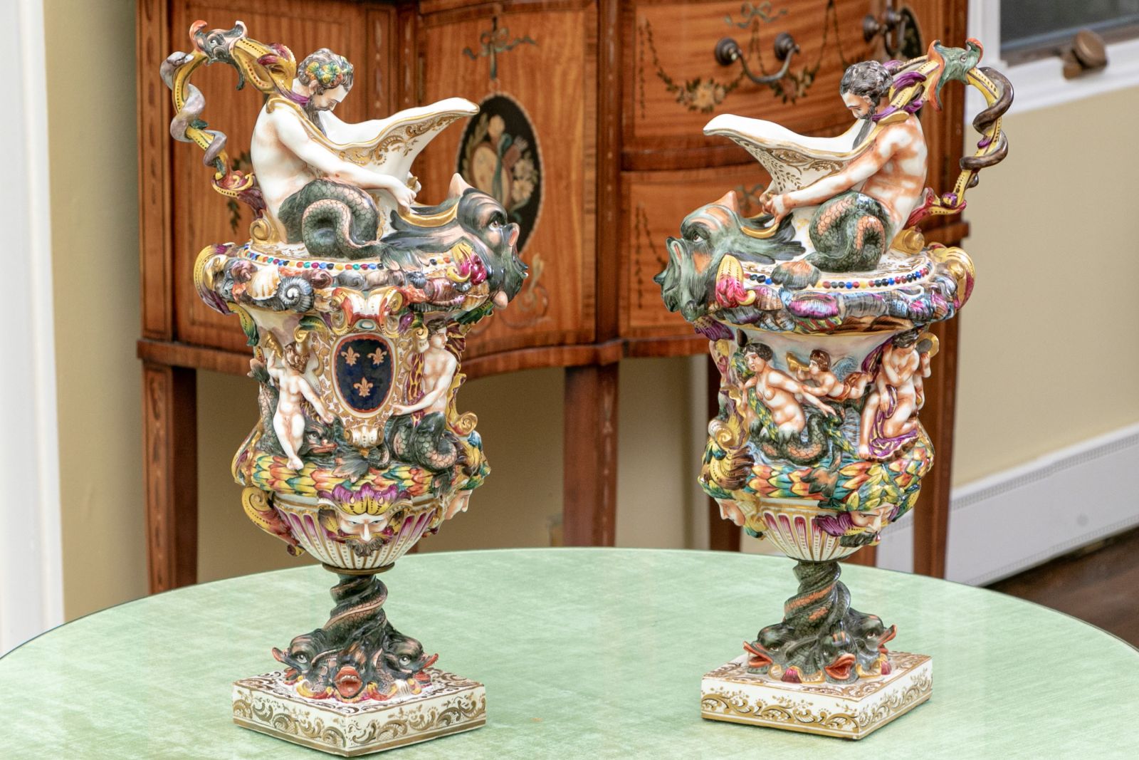 A monumental pair of Crown Naples Capodimonte porcelain ewers